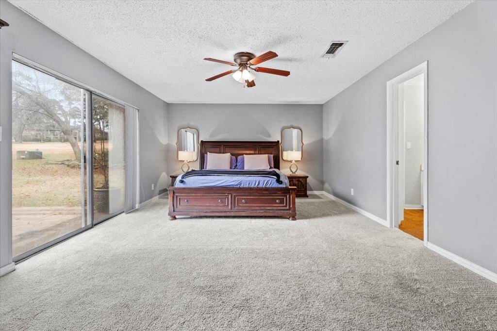Generously sized primary suite with patio access.