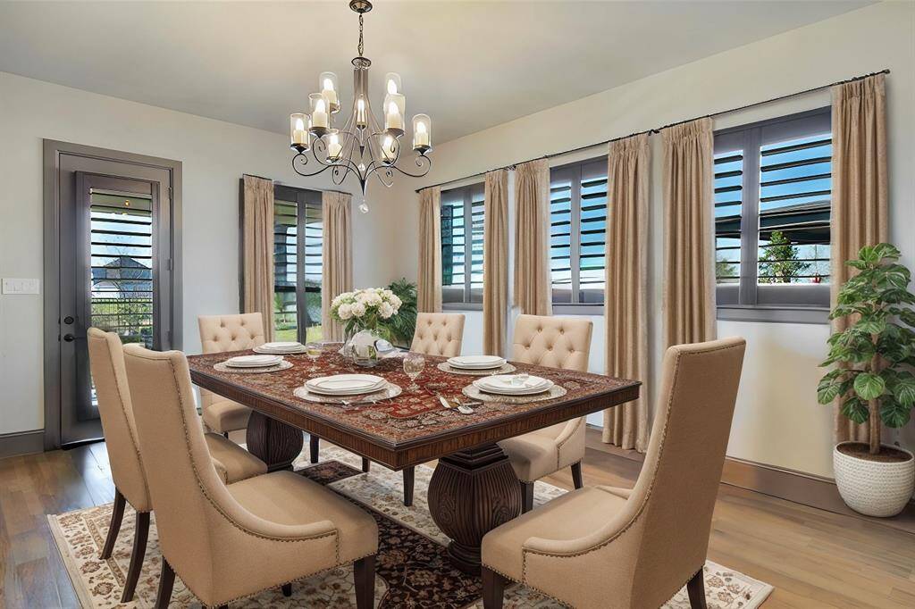 The dining area offers a picturesque view of the backyard, filling the space with natural light. Its open design creates a seamless connection between indoor and outdoor living.