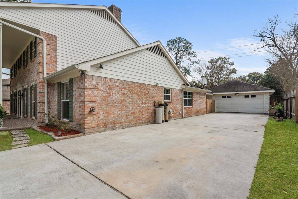 The exterior features a blend of brick and siding and ample parking and garage space.