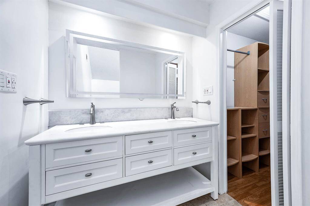 Primary Vanity updated with Illuminated Vanity, Double Sinks & Quartz Countertop with tons of space & GFCI outlets on both sides.