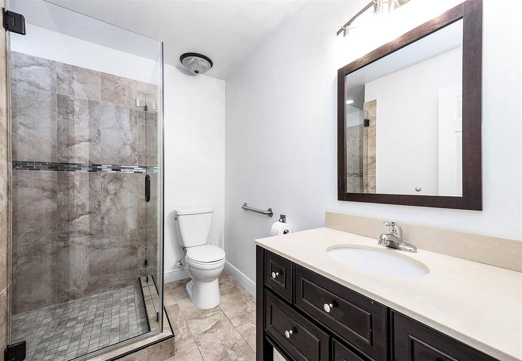 Fully remodeled Hallway Bath, Tile, Glass Doors, vanity, lighting & toilet