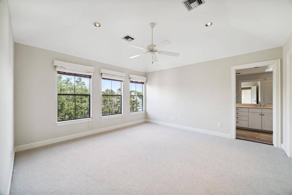 Primary bedroom features new carpet, crown molding and beautiful North facing windows.