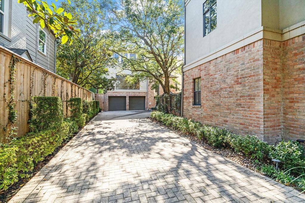 Street view of the home secluded at the back of the lot.