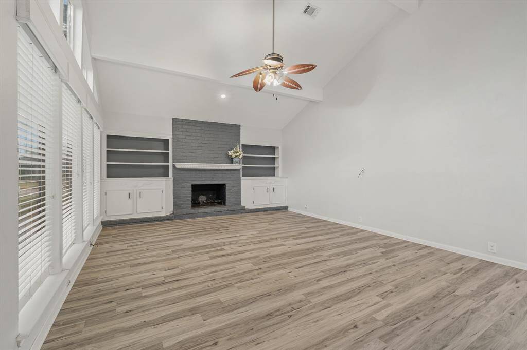 Another view of the Living Room features built-in cabinetry surrounding the cozy fireplace and mantel.