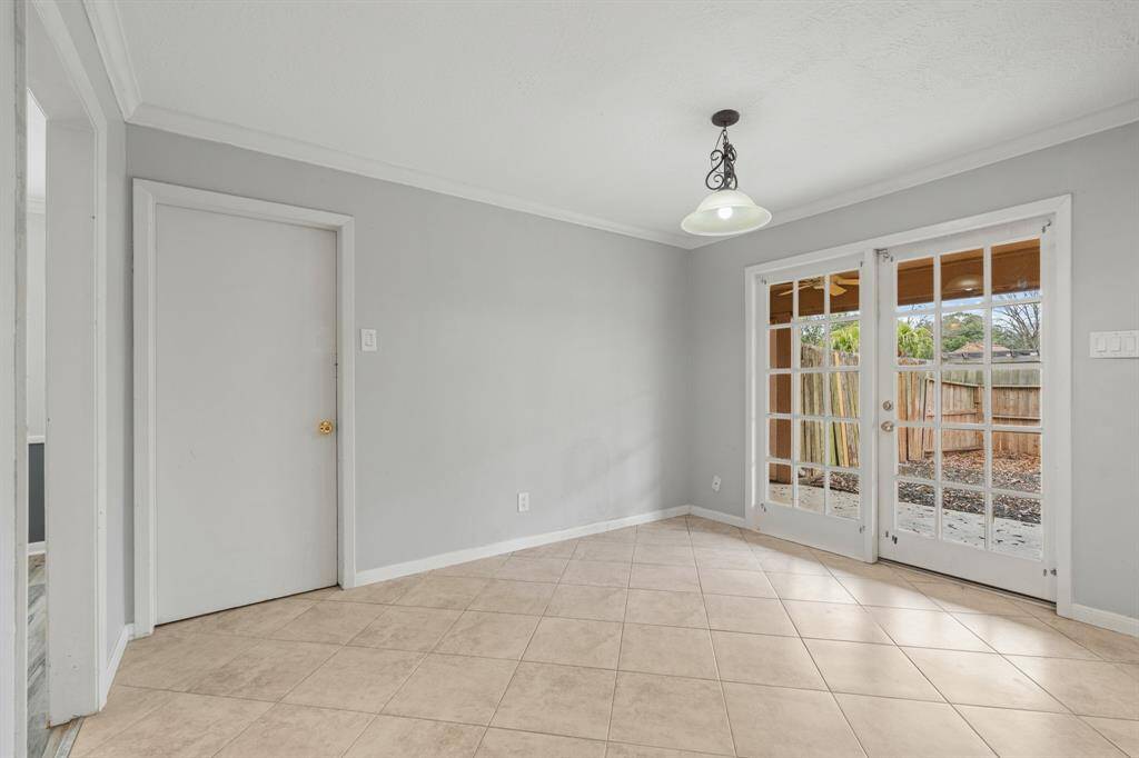 This breakfast room has access to the utility room.