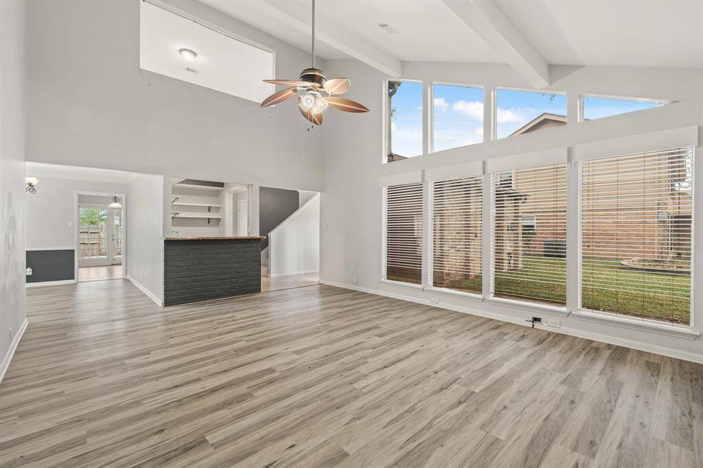 Large Living Room with High Ceilings features vinyl flooring. Great floorplan for entertaining.