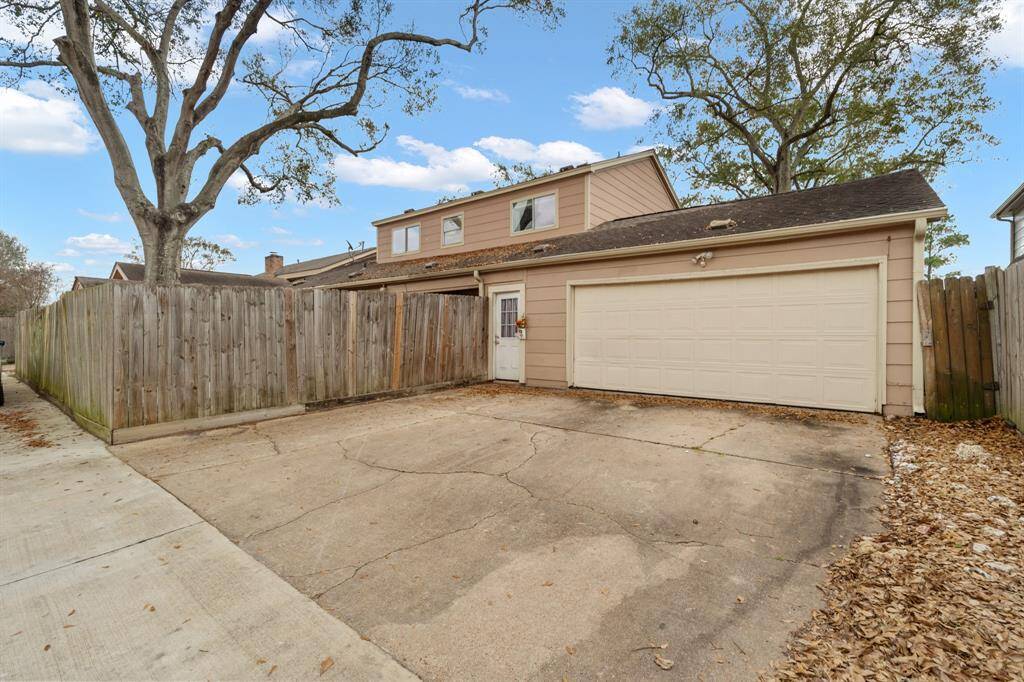 View of entrance to the back yard from a private alleyway.