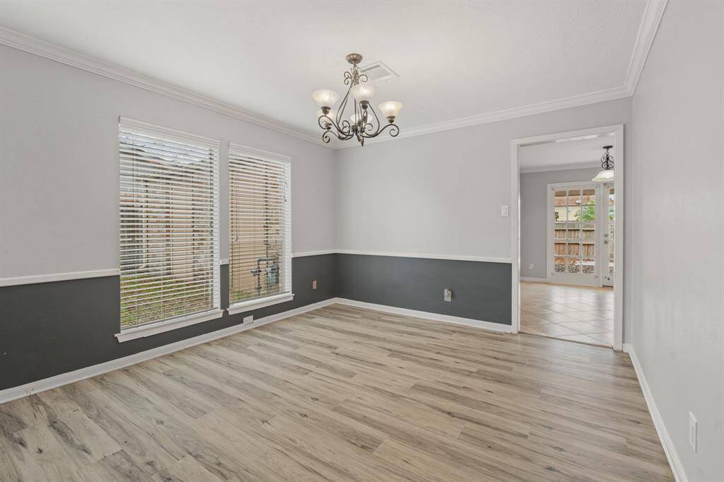 Formal Dining features crown molding, chair rail and vinyl flooring. Easy access to the Kitchen.