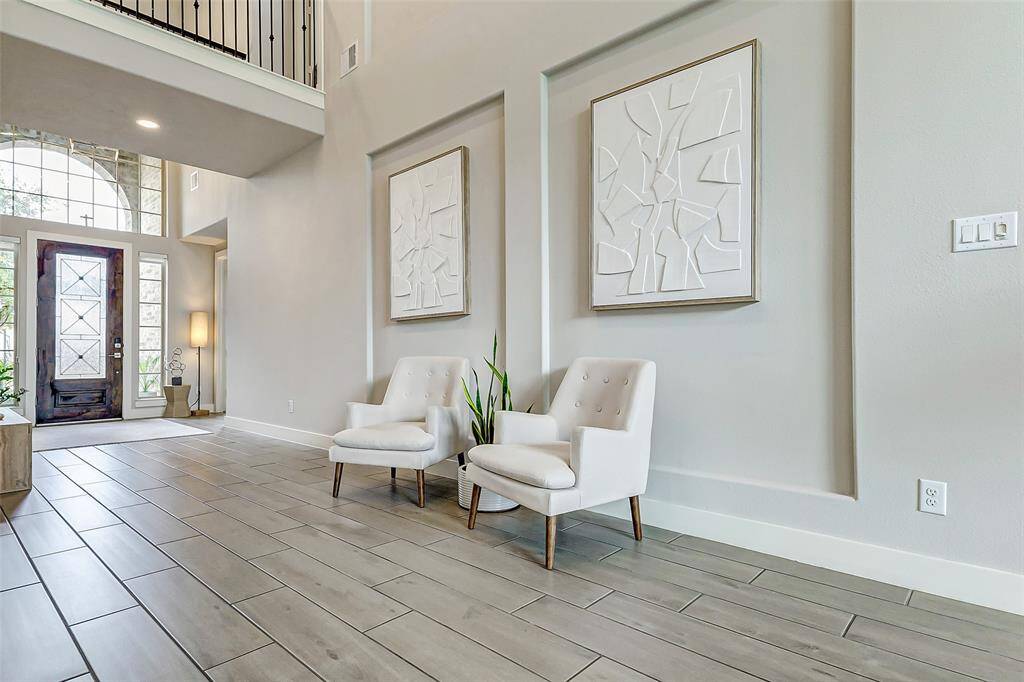 Bright entryway with modern tile flooring and high ceilings, creating a welcoming atmosphere.