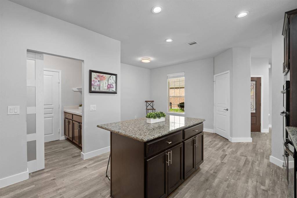 Here’s a view from the kitchen, where you can easily see the charming breakfast nook and the convenient laundry room. A bonus feature is the window that allows you to view guests while filling the space with natural light, creating a bright and airy atmosphere throughout.