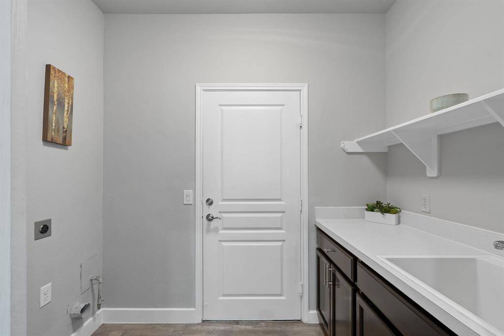 As you step in from the garage, you’re welcomed by a utility/laundry room featuring shelves and cabinets for added storage. The sink, gas or electric dry connections are a rare find in many Del Webb homes, is a fantastic upgrade, offering added convenience and functionality to the space.