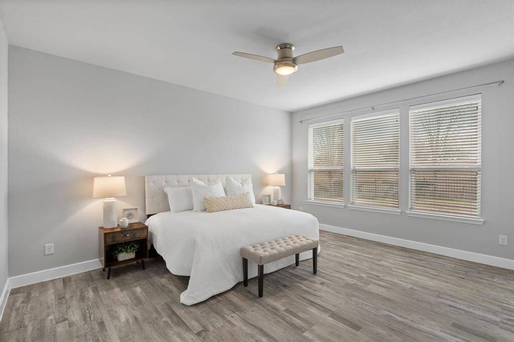 The Owner's suite serves as a tranquil retreat, featuring serene views of your private backyard. With no carpet throughout, the home maintains a sleek and modern aesthetic. A contemporary ceiling fan with remote control enhances comfort and adds a touch of style.
