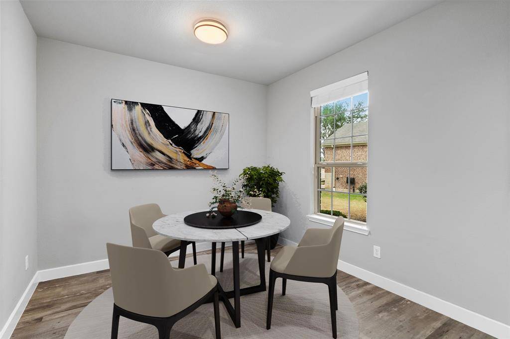Here is an example of a round table with 4 chairs would be perfect for the space. (Virtually staged)