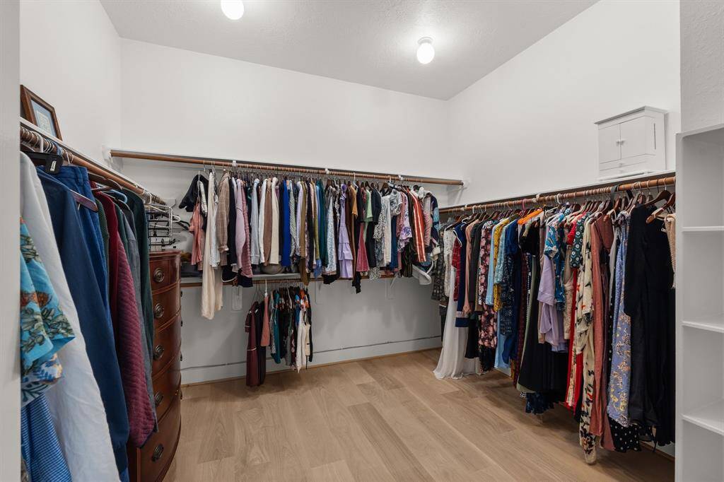 The primary closet has storage shelves and plenty of space that awaits your personal style!
