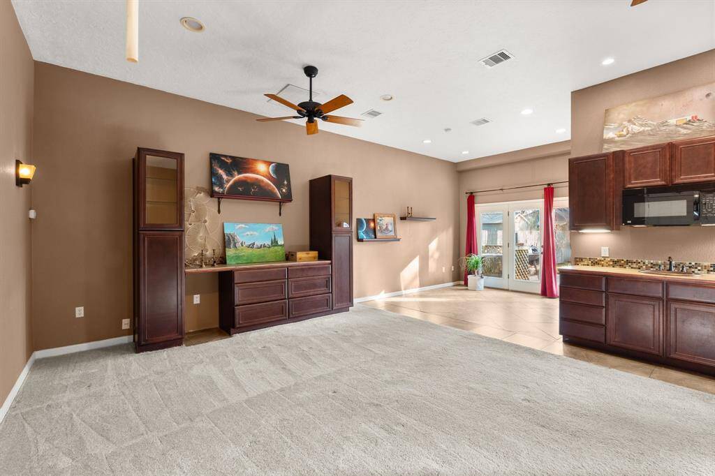 The separate guest house can be used as an additional bedroom suite with wet bar, microwave, and full bath.