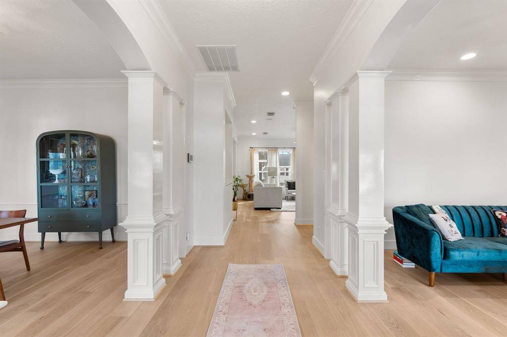 You are greeted by elegant white columns framing the new solid white oak hardwood floors. On your left is the formal dining room, and on your right is the formal living area.