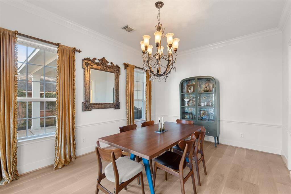 This formal dining room is ready for your next dinner party with an elegant chandelier, and another set of French doors which open to the front porch.