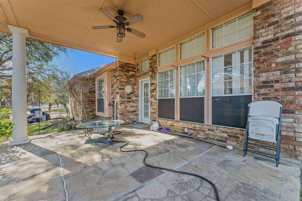 Charming brick home with large windows and a welcoming entrance, nestled between mature trees and well-maintained landscaping. Ideal for those seeking a blend of natural beauty and curb appeal.