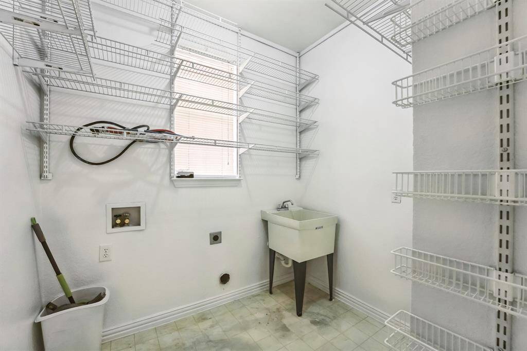 Charming brick home with large windows and a welcoming entrance, nestled between mature trees and well-maintained landscaping. Ideal for those seeking a blend of natural beauty and curb appeal.