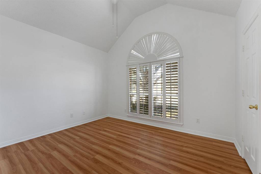 Charming brick home with large windows and a welcoming entrance, nestled between mature trees and well-maintained landscaping. Ideal for those seeking a blend of natural beauty and curb appeal.