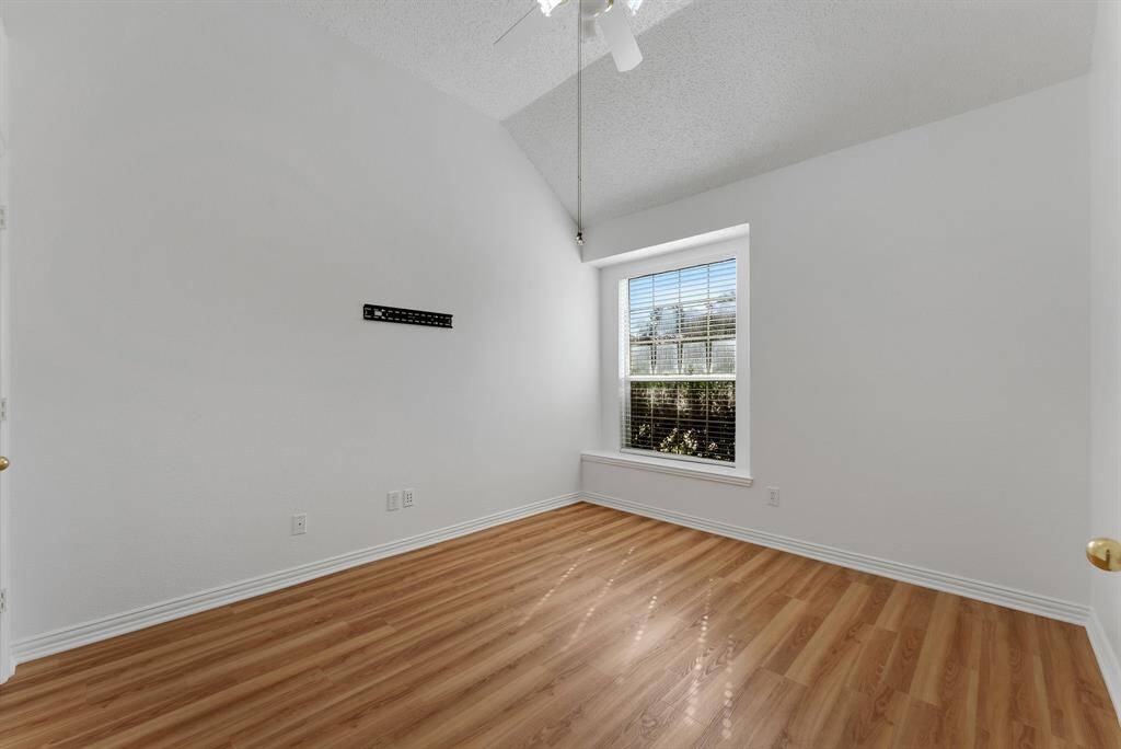 Charming brick home with large windows and a welcoming entrance, nestled between mature trees and well-maintained landscaping. Ideal for those seeking a blend of natural beauty and curb appeal.