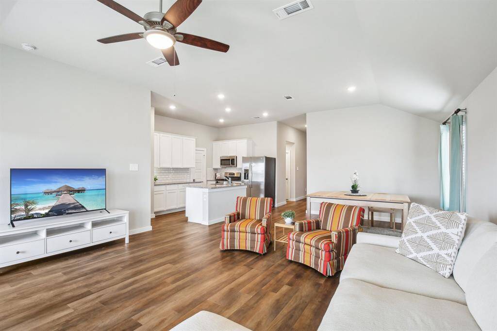 Open floorplan with living room that flows into dining room and kitchen.