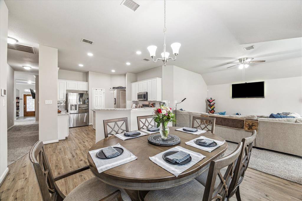 Spacious breakfast area, kitchen, and family room—perfect for entertaining.