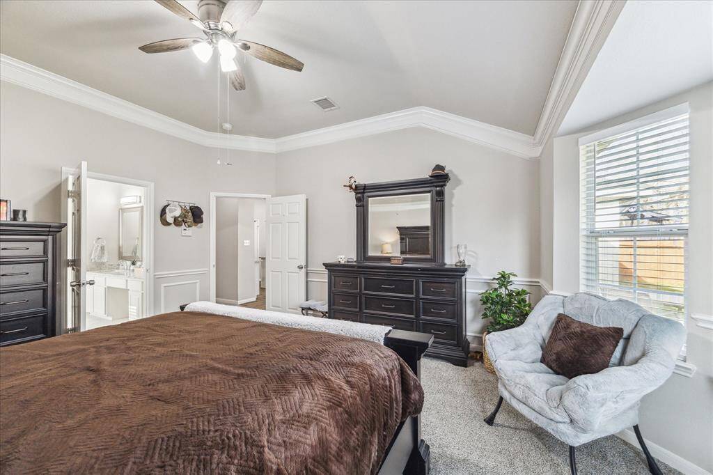 Elegant crown molding enhances the sophistication of this primary suite.