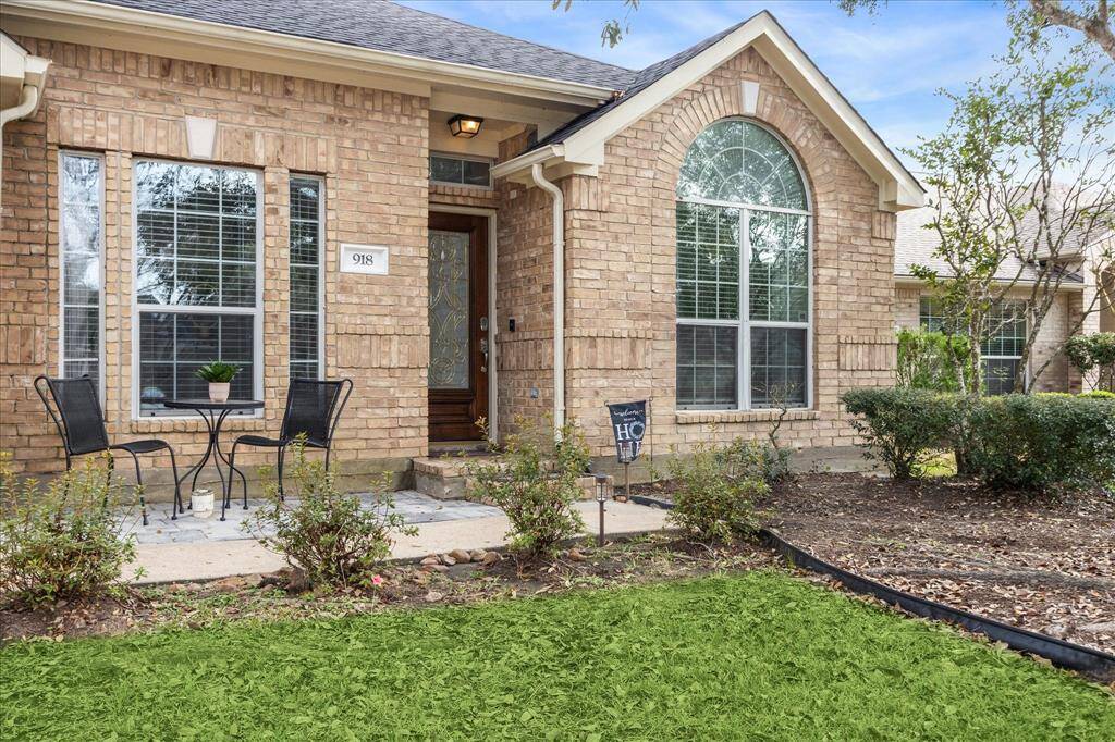 Welcoming front porch with inviting entry and lush landscaping. Perfect blend of style and comfort.