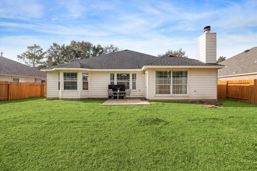 Inviting backyard with a charming patio, perfect for outdoor relaxation and entertaining.