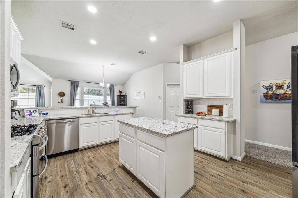 Ample cabinetry and expansive meal prep space makes this kitchen a chef's delight.