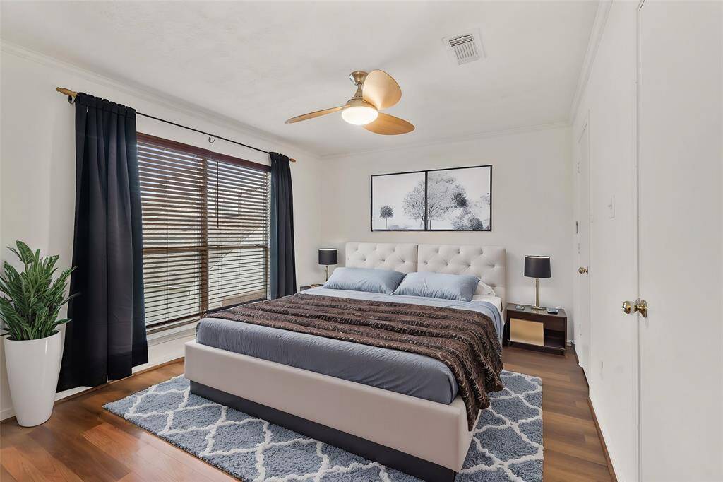 Virtually Staged: No better place to recharge after a busy day than this stunning Primary Bedroom. Highlighting its beautiful high ceilings, wood floors, lage windows, ceiling fan, and walk-in closet.