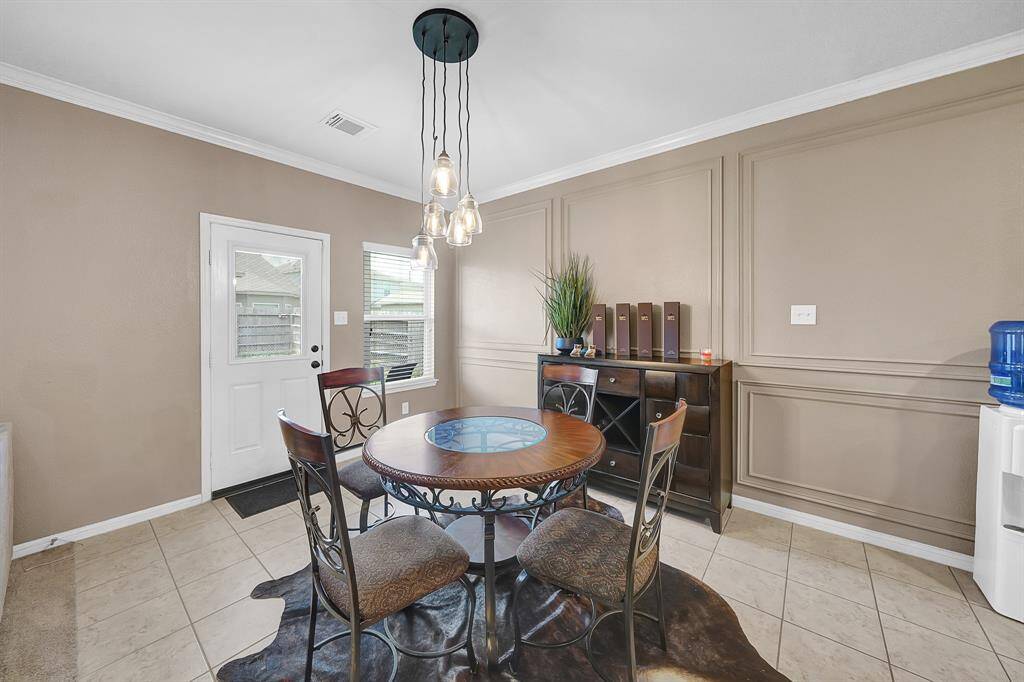 Breakfast area features designer paneling and paint and updated fixture
