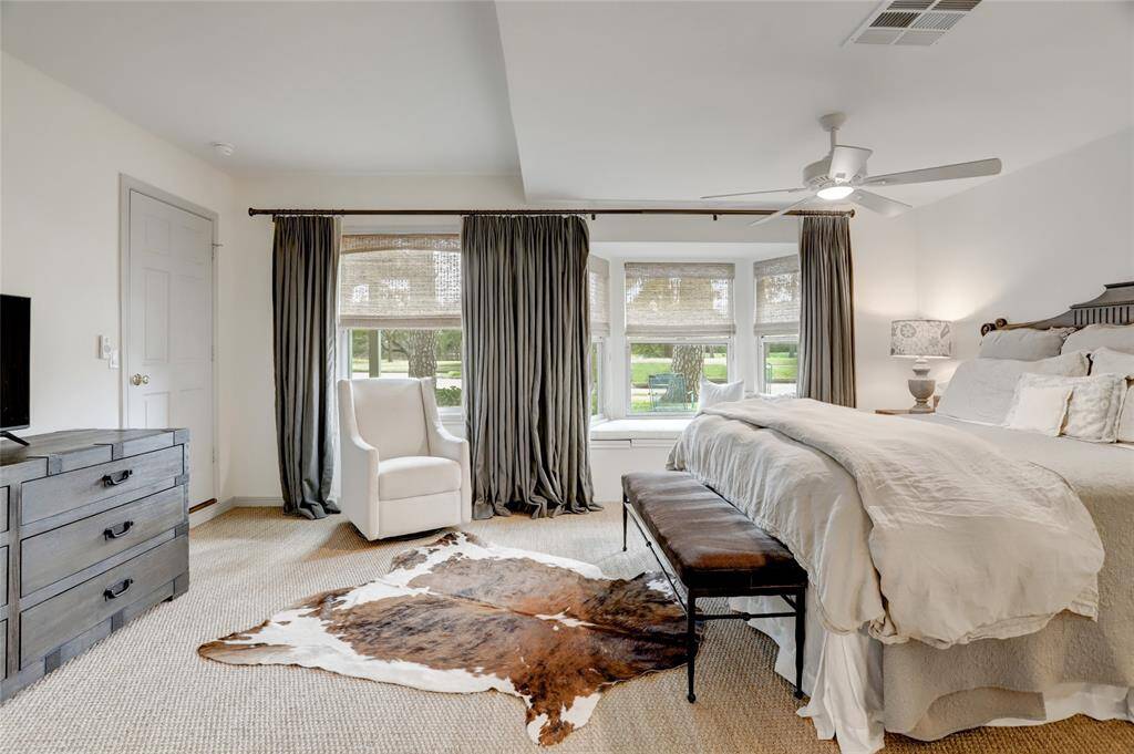 View of the primary bedroom from the bathroom entry.