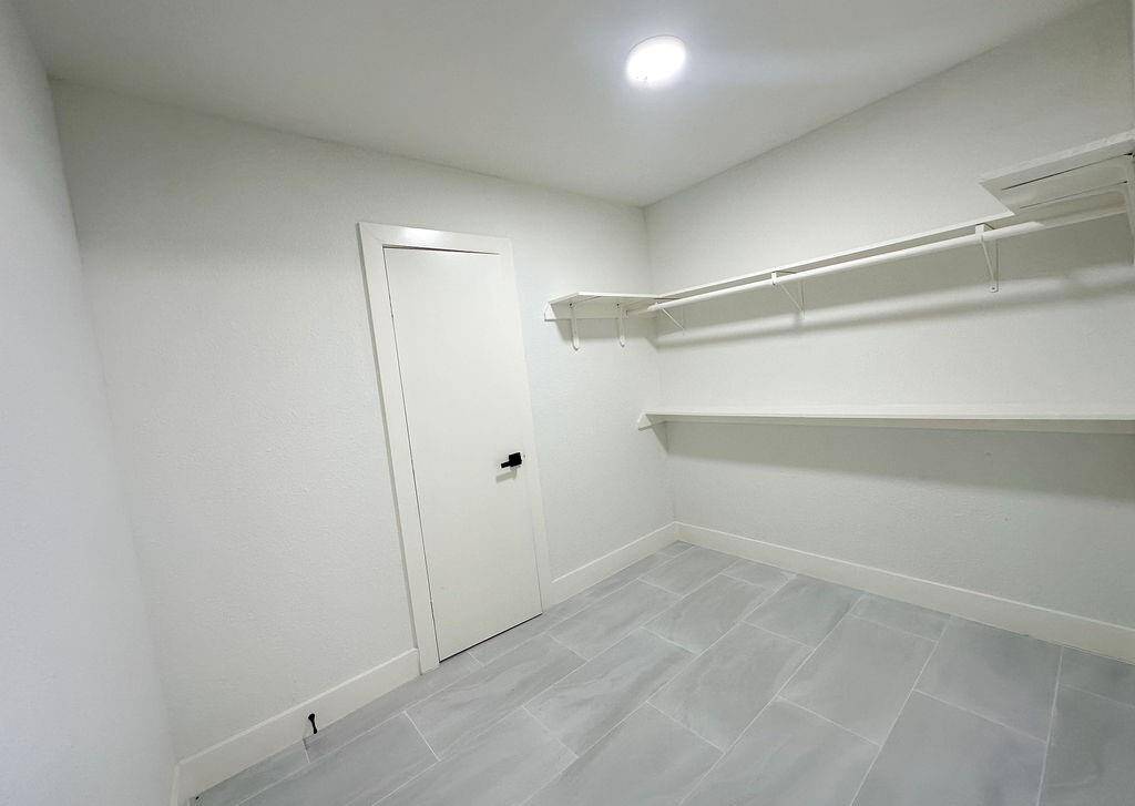 Renovated laundry room conveniently located next to the kitchen for easy access.