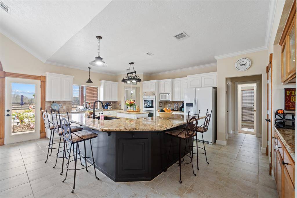 Moving into the kitchen, there is tons of counter space, perfect for gathering together for a meal!