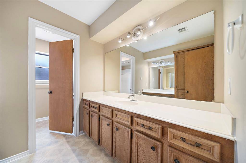 Secondary full bath is located off the hallway. Tub/shower combo with single vanity and extra storage.