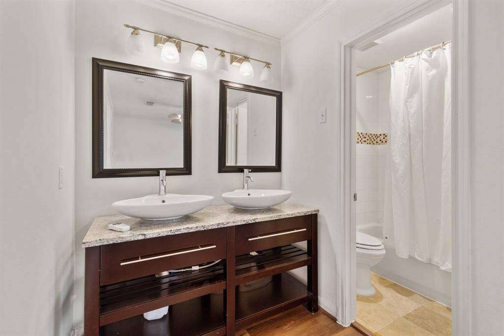 Beautifully appointed vanity area featuring his/her sinks, framed mirrors and vanity lights!
