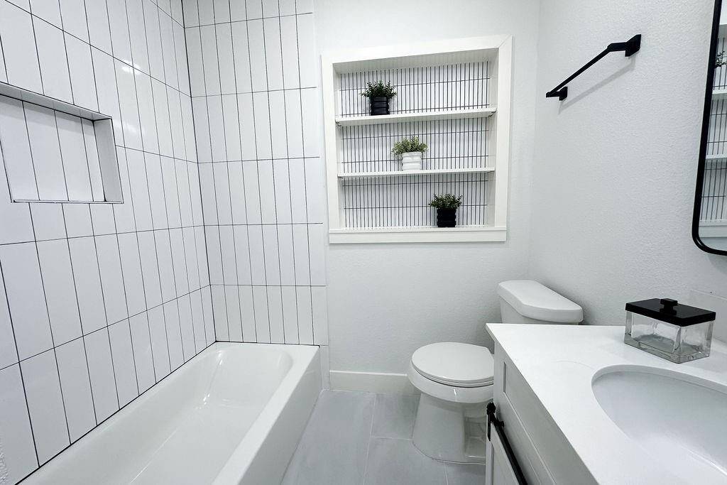 Fully renovated bathroom with modern finishes and updated fixtures.