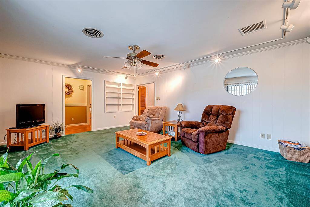This spacious family room offers a versatile layout, ready to be transformed to fit your lifestyle and design preferences. Whether you prefer a sleek contemporary look, a rustic cozy vibe, or a classic family-friendly setup, this room is a blank canvas, waiting to be reimagined into your dream living space.