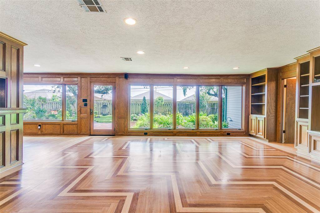 The family room features beautiful block paneling; custom bookcases and cabinets - the shelving is adjustable for all of your books or a perfect place to display your family treasures.