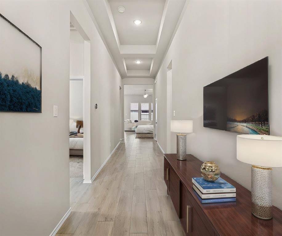 Upon entry, you’ll be greeted with beautiful 12-ft. custom coffered ceilings and a wide entry way