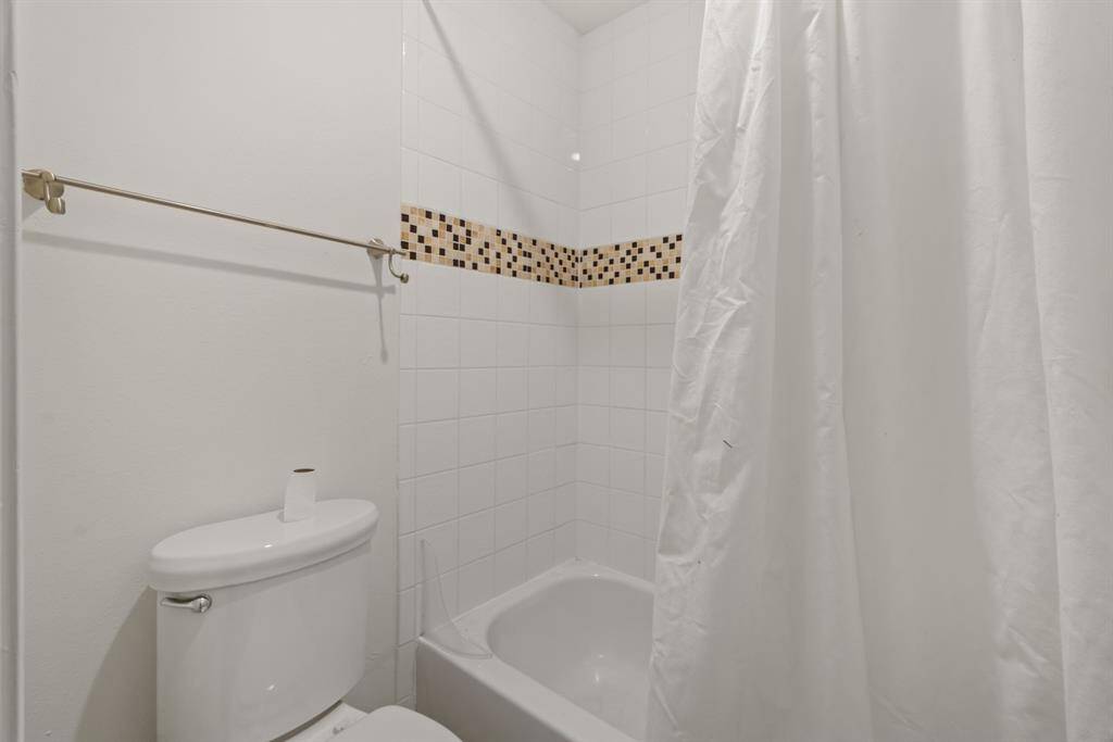 This primary bathroom is complete with a shower/tub combo.