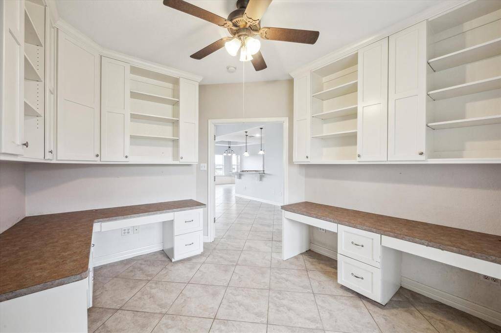 Home office with lots of custom built in cabinets and closet for storage