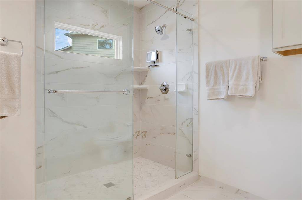 The spacious glass-wall shower in the primary.