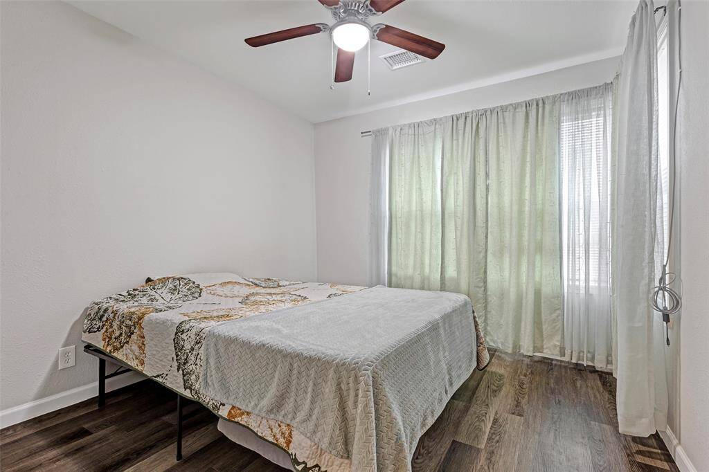 One of the secondary bedrooms, a blank canvas ready for the new owner to design and style with their unique touch and creativity.