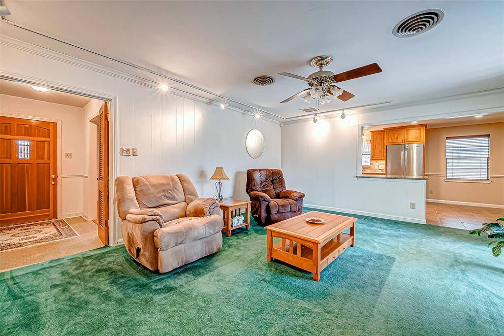 This view of the family room highlights its seamless connection to the kitchen, creating an open and inviting atmosphere perfect for both everyday living and entertaining.