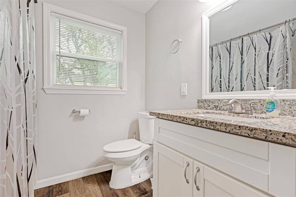 Bright and functional secondary bathroom featuring a single sink, offering convenience and simplicity for everyday use."