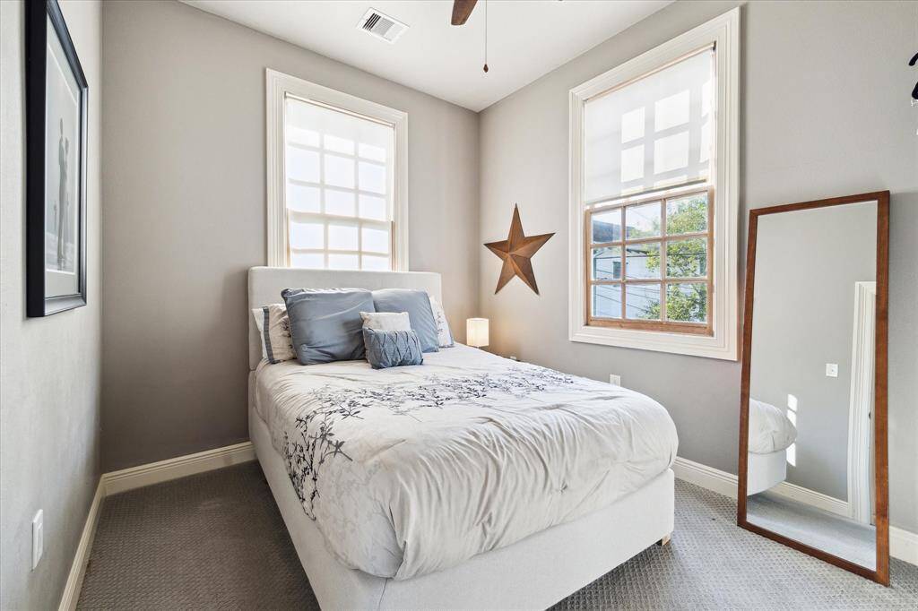 Two corner bedrooms feature double exposures, cozy carpeting and ceiling fans