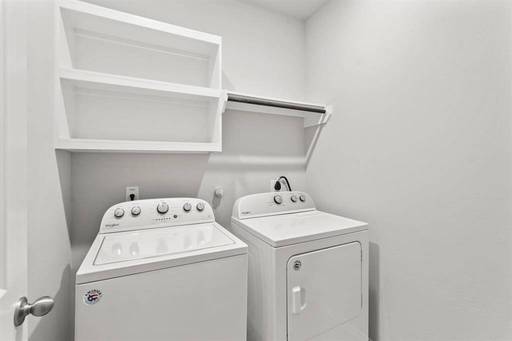 Spacious laundry room with built in shelves